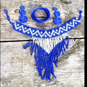 A set of jewelry, necklace, earrings, and a bangle.